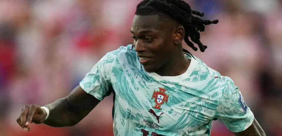Jugador de Portugal corriendo con balón en el campo