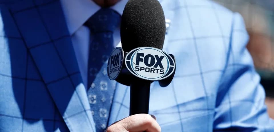 Mic with FOX Sports logo held by a person