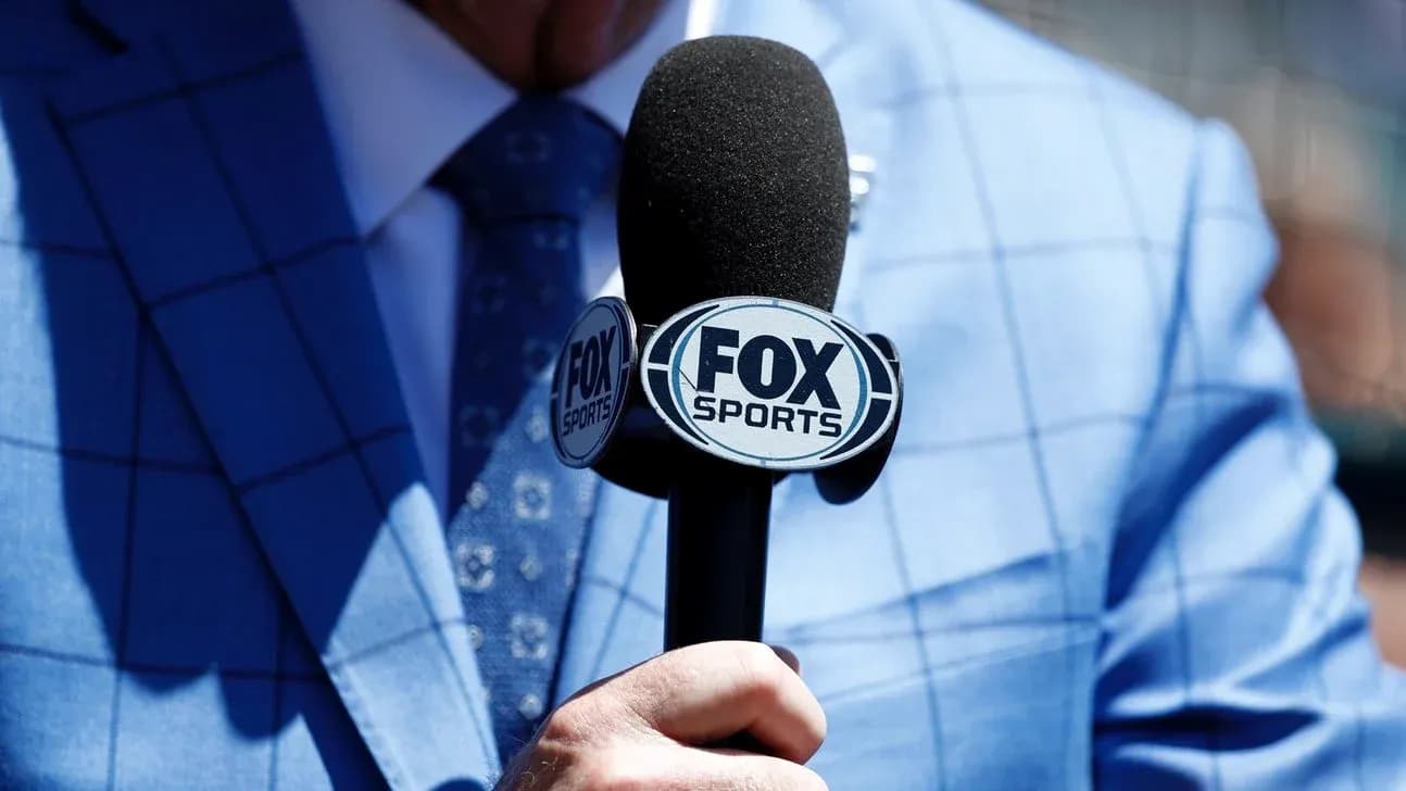 Mic with FOX Sports logo held by a person