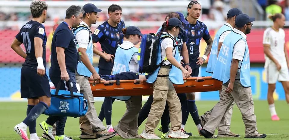 Equipo médico trasladando a un jugador en camilla