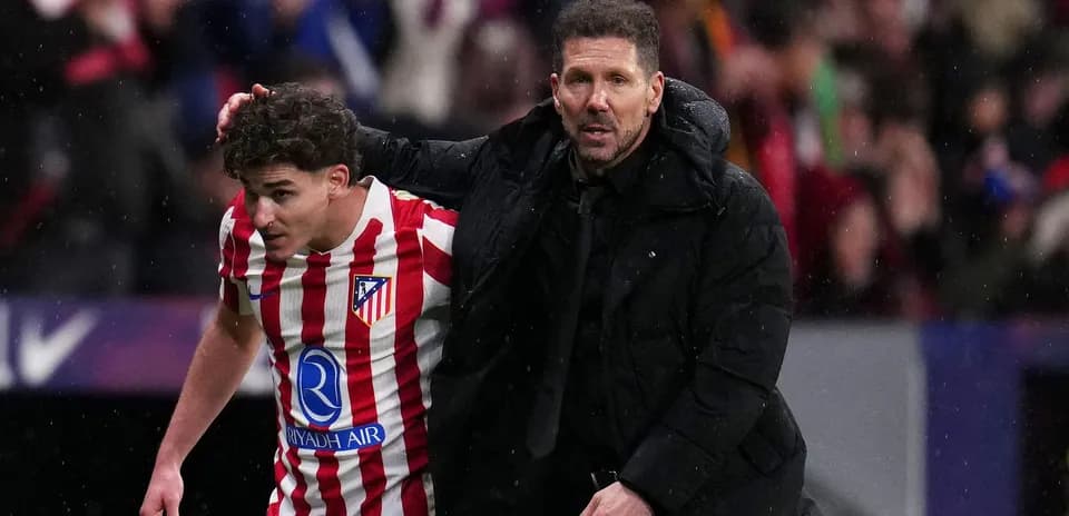 Entrenador apoyando a jugador de Atlético de Madrid