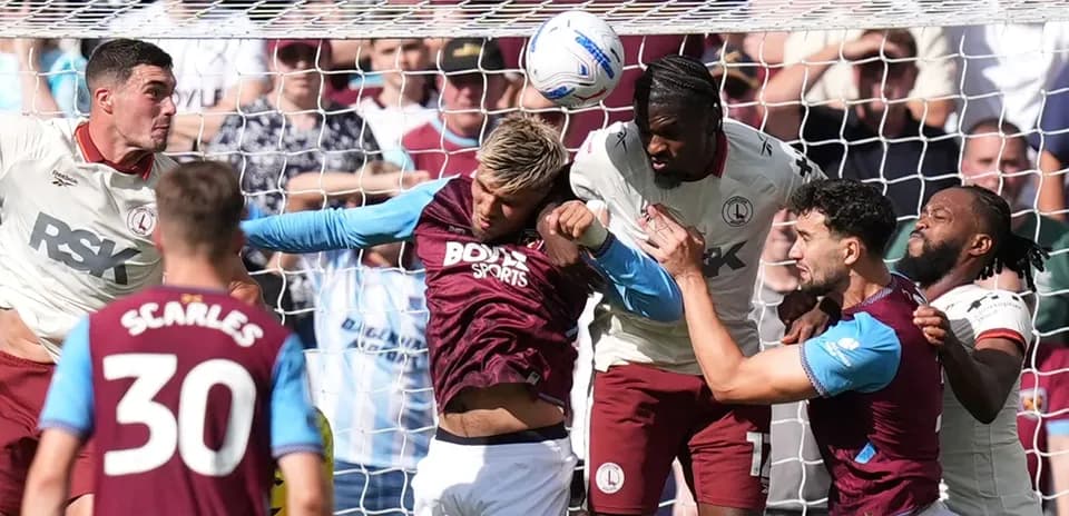 Jugadores disputando un balón en el área de gol