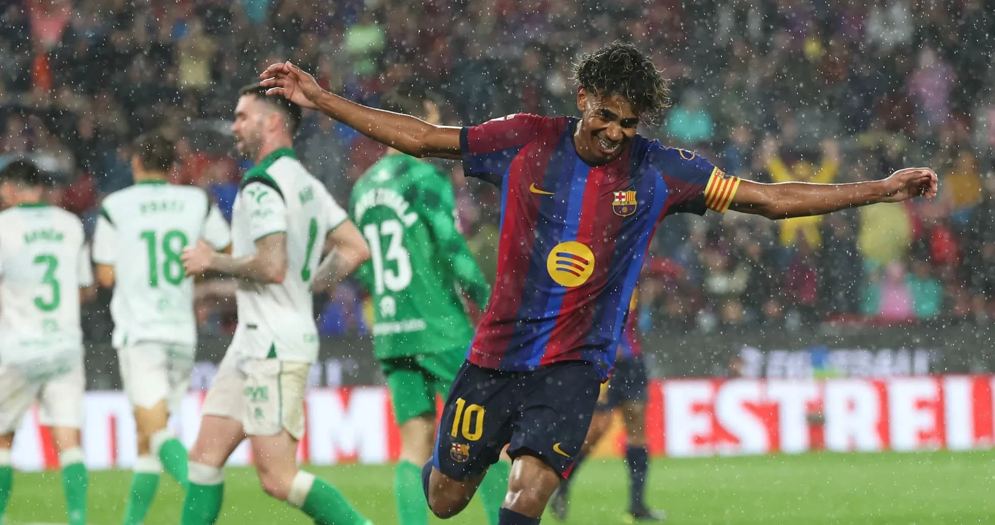 Jugador de Barcelona celebrando en lluvia durante el partido