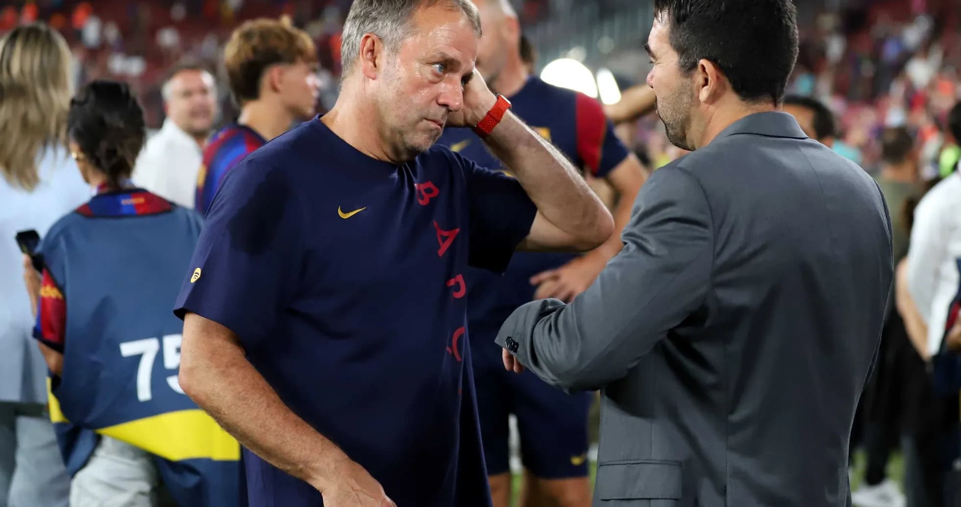 Entrenador conversando con asistente en el campo