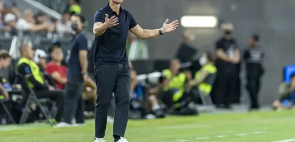 Entrenador gesticulando en la línea de banda
