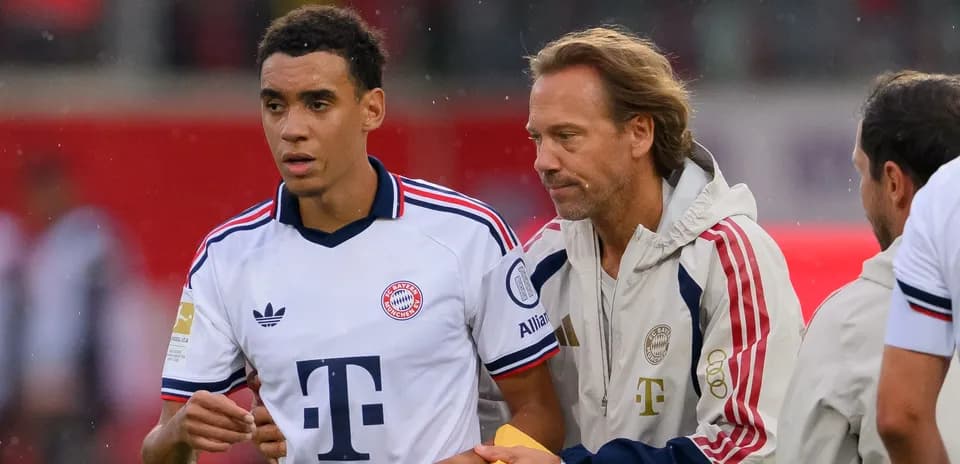 Jugador de Bayern Múnich siendo atendido por entrenador