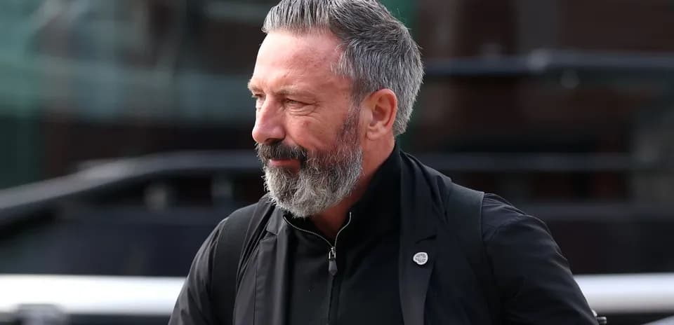 Hombre con barba gris caminando hacia el estadio