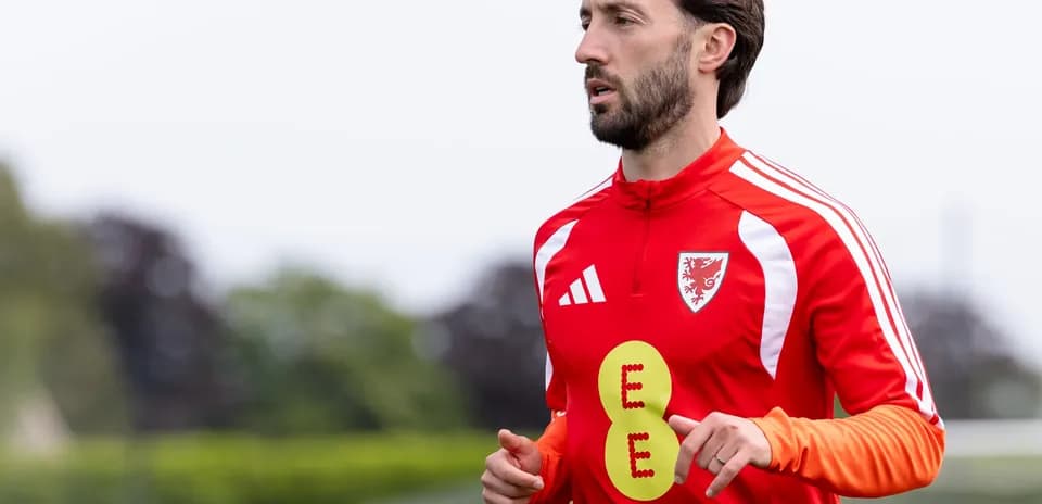 Jugador entrenando en camiseta roja con insignia