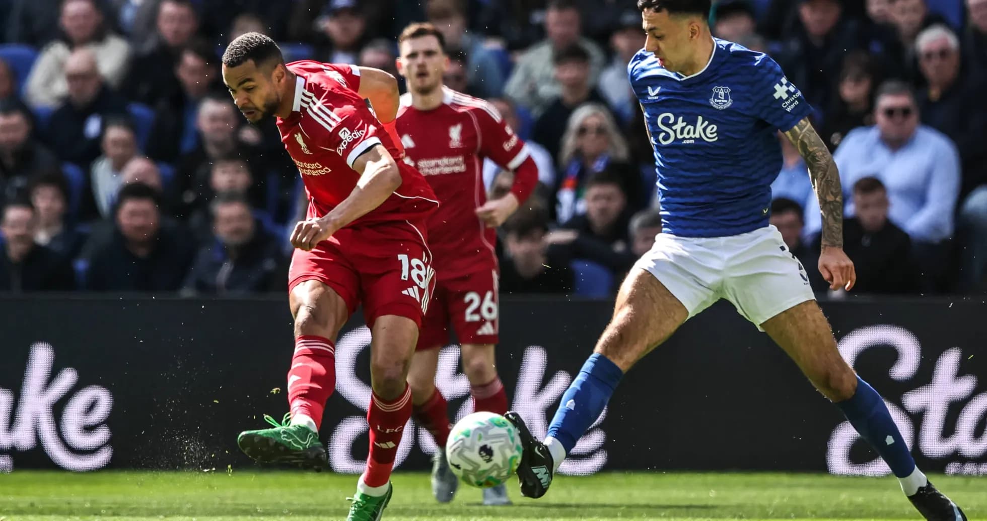 Jugador de Liverpool driblando frente a rival de Everton