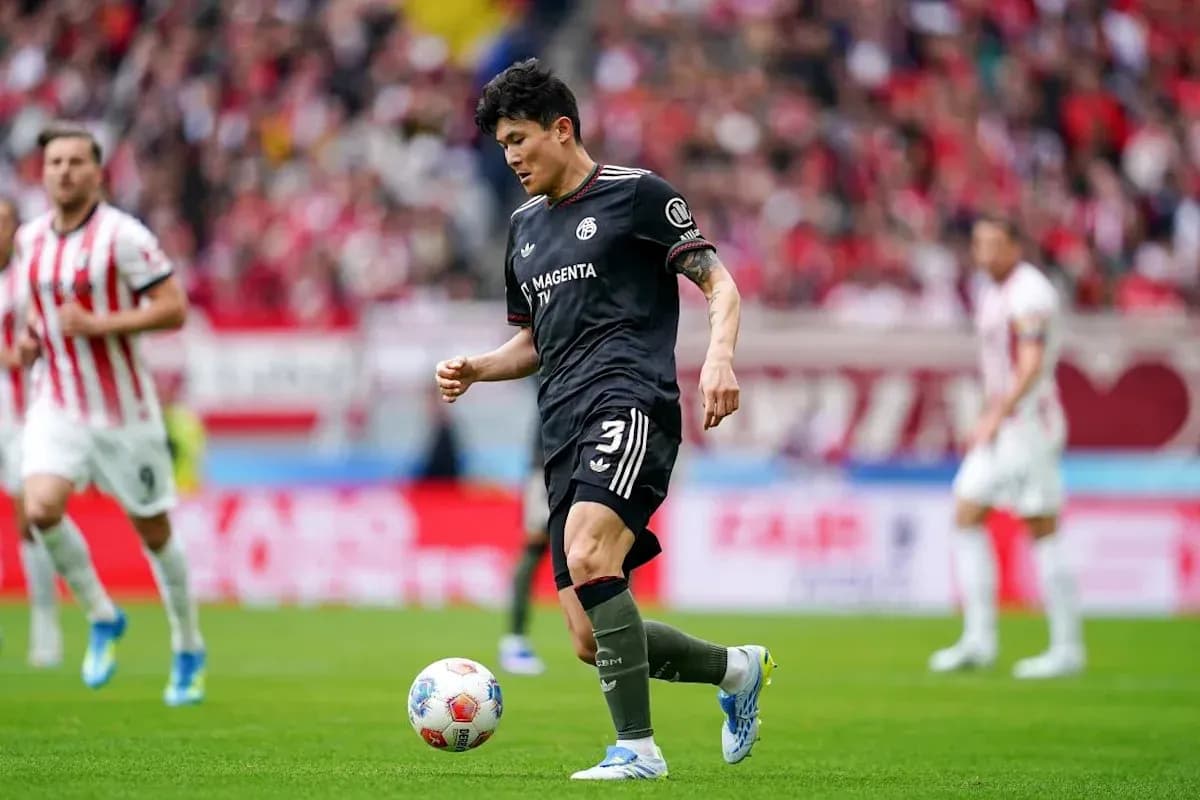 Jugador en acción con balón durante partido de fútbol