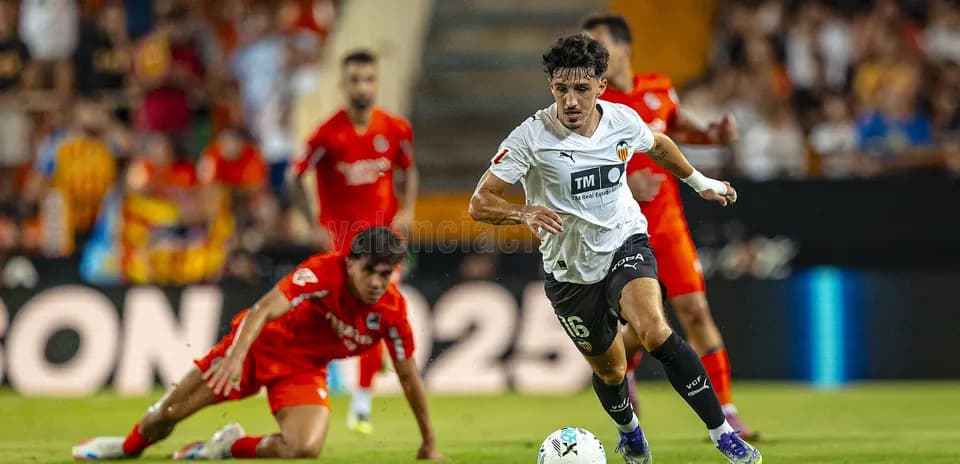 Jugador de Valencia corriendo con el balón