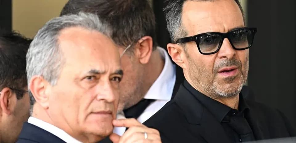Dos hombres en trajes oscuros con gafas de sol