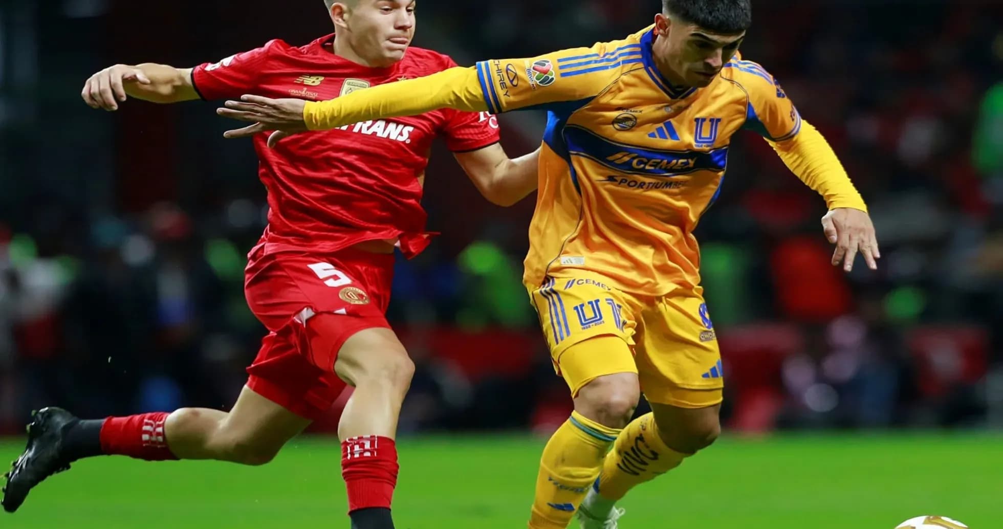 Toluca y Tigres UANL compitiendo por el balón
