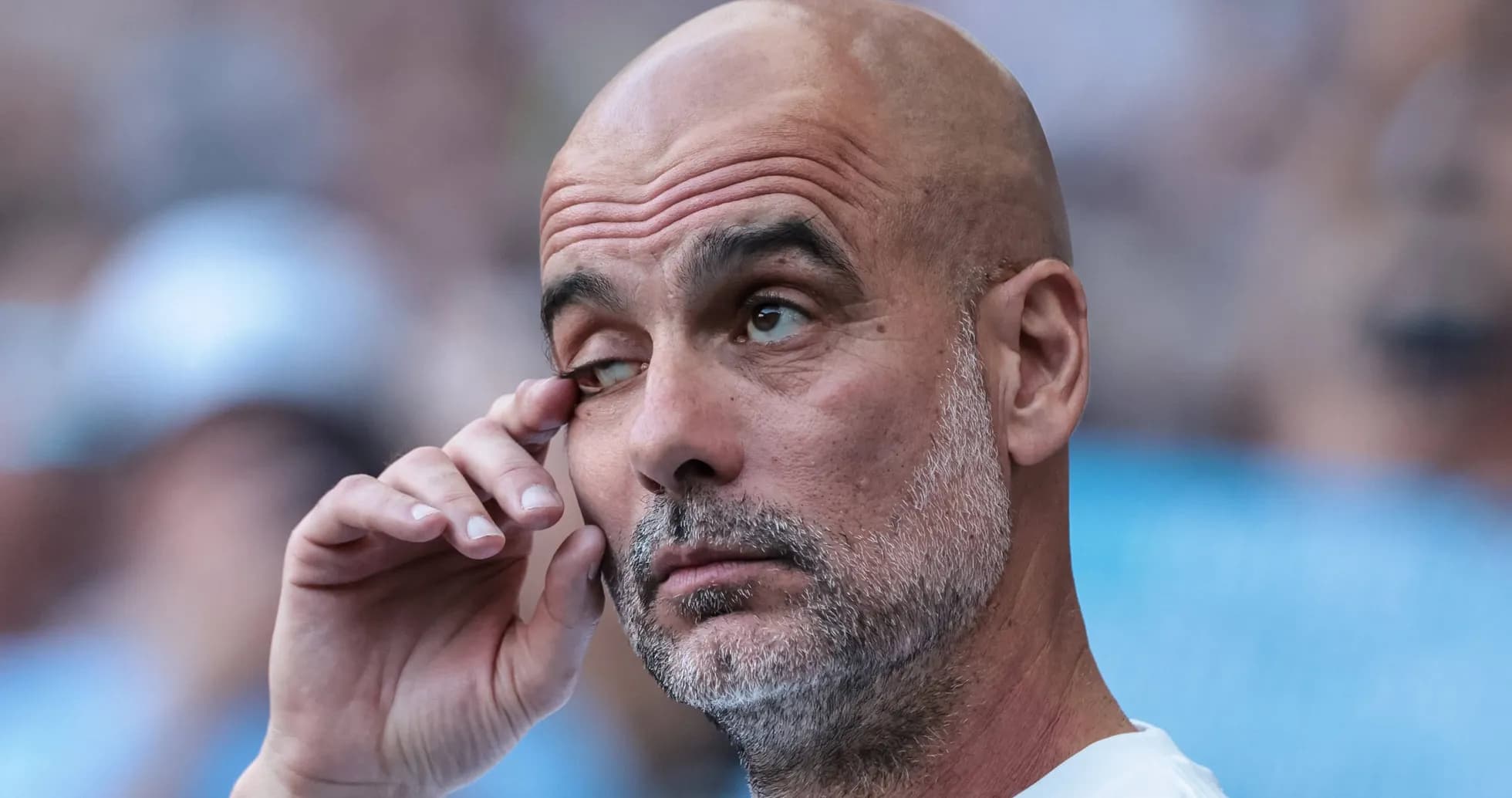 Entrenador tocándose el ojo durante el partido