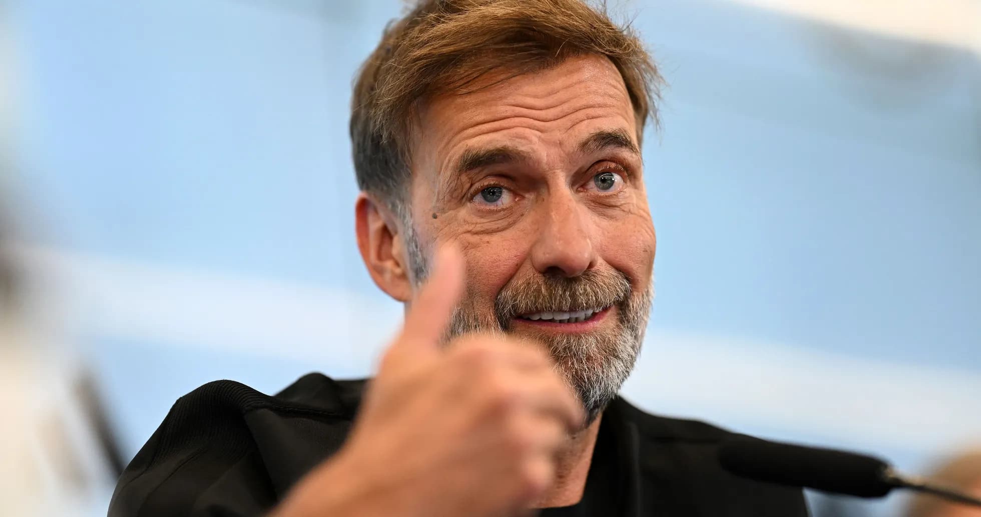 Entrenador mostrando el pulgar hacia arriba en conferencia
