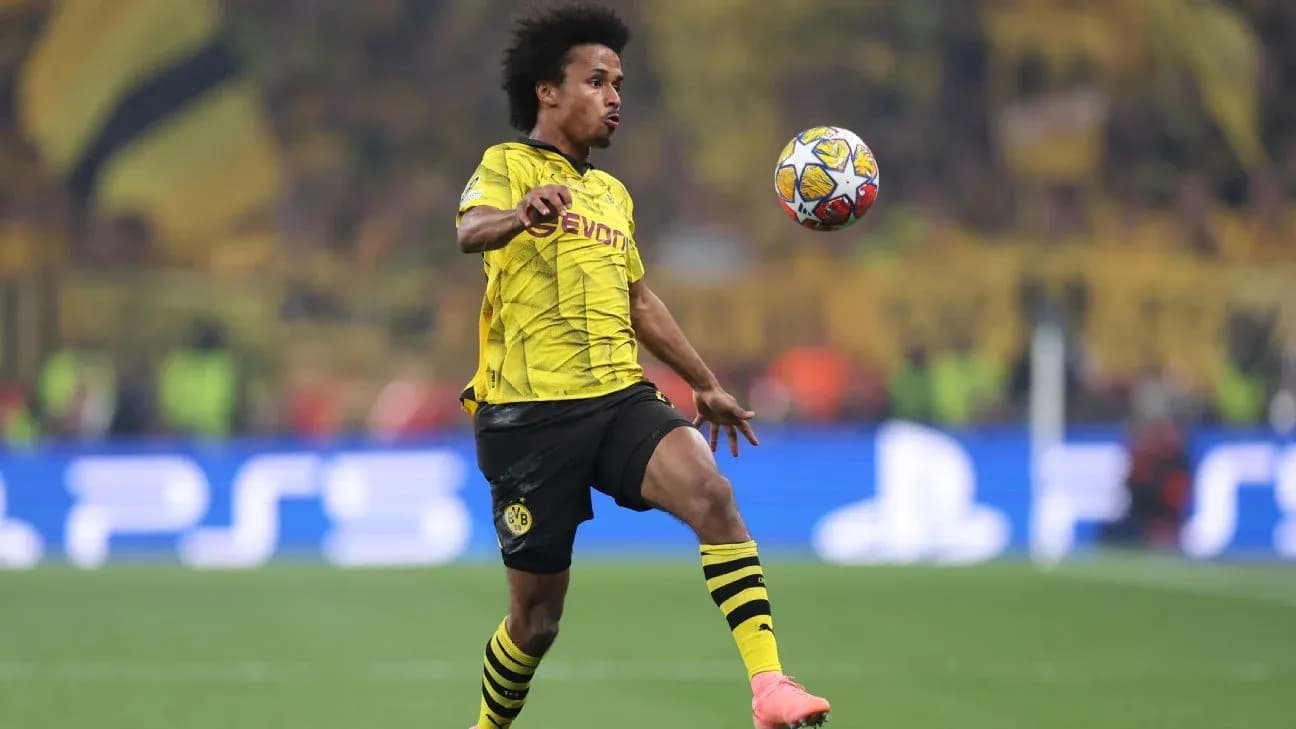 Jugador de Borussia Dortmund controlando el balón en el campo Jugador de Borussia Dortmund controlando el balón en el campo