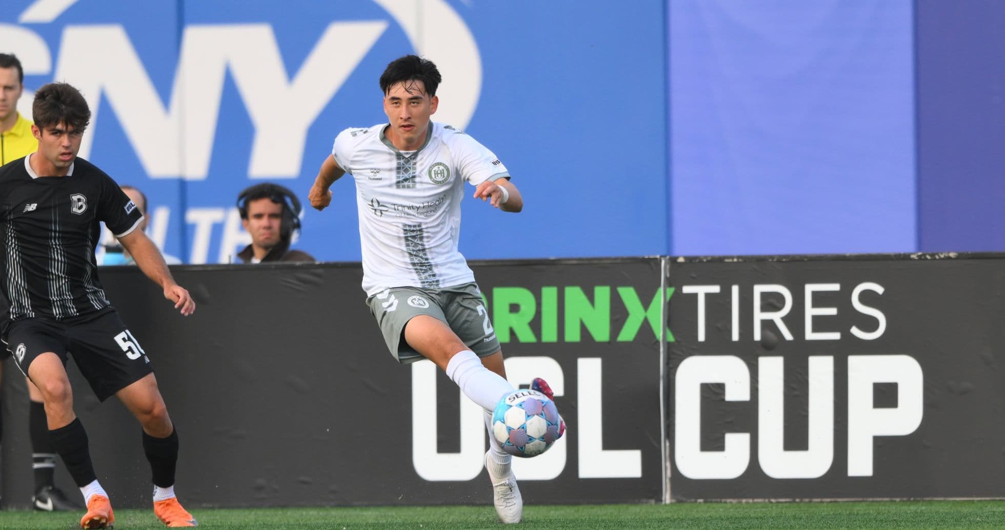 Jugador de Hartford Athletic persiguiendo el balón Jugador de Hartford Athletic persiguiendo el balón