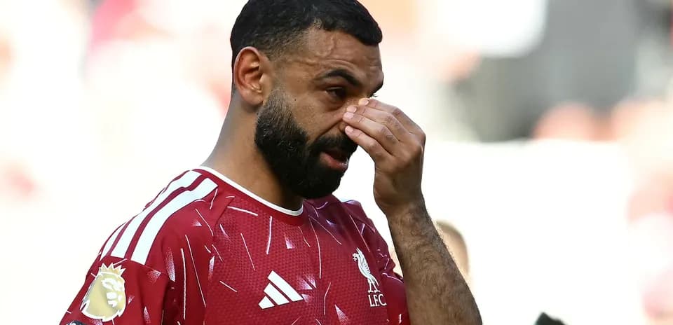 Jugador de Liverpool tocándose la cara en el campo Jugador de Liverpool tocándose la cara en el campo