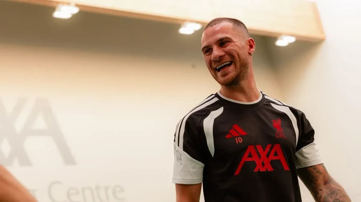 Jugador de Liverpool sonriendo en la sala de entrenamiento Jugador de Liverpool sonriendo en la sala de entrenamiento
